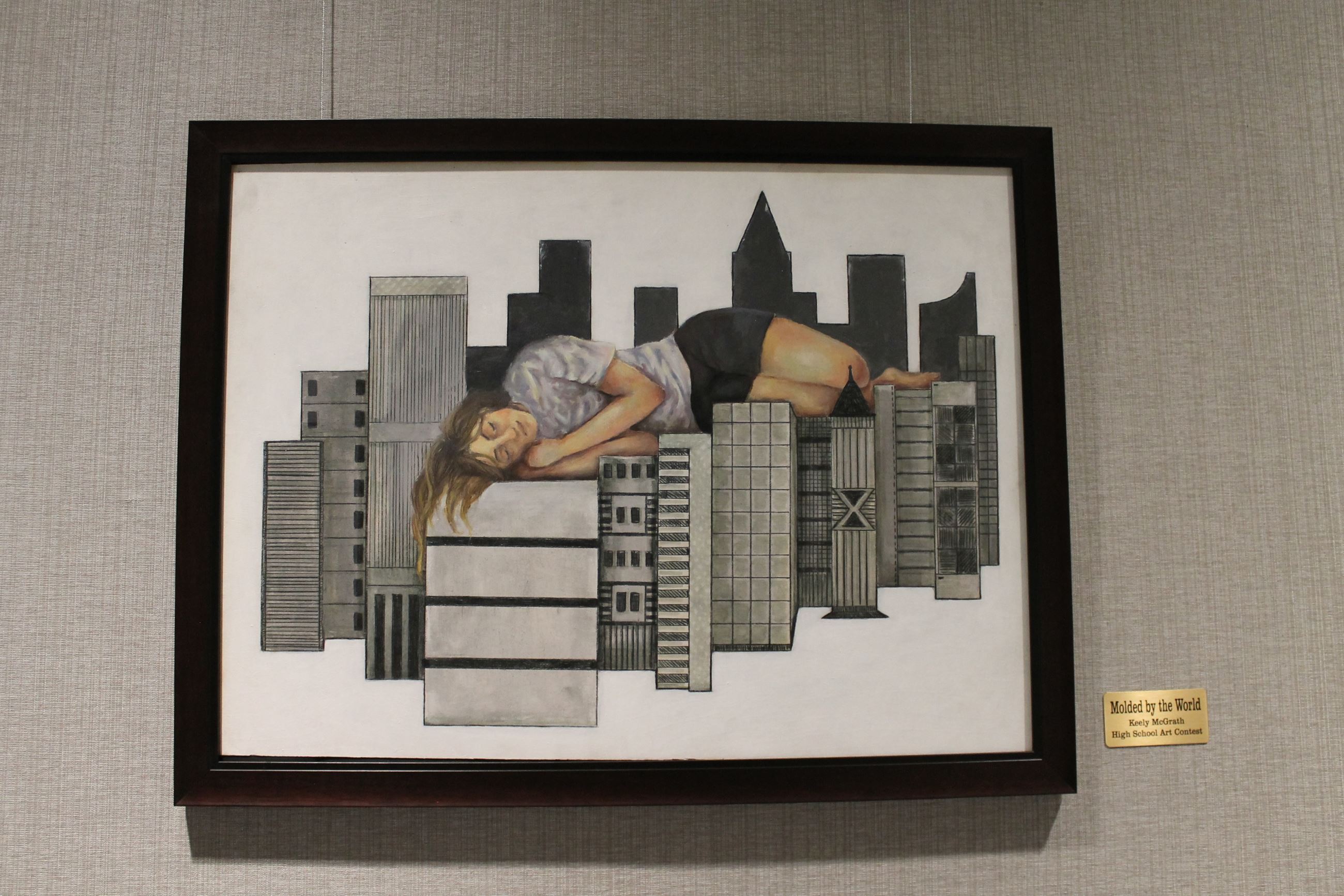 Picture of a painting with a young woman laying across a cityscape 