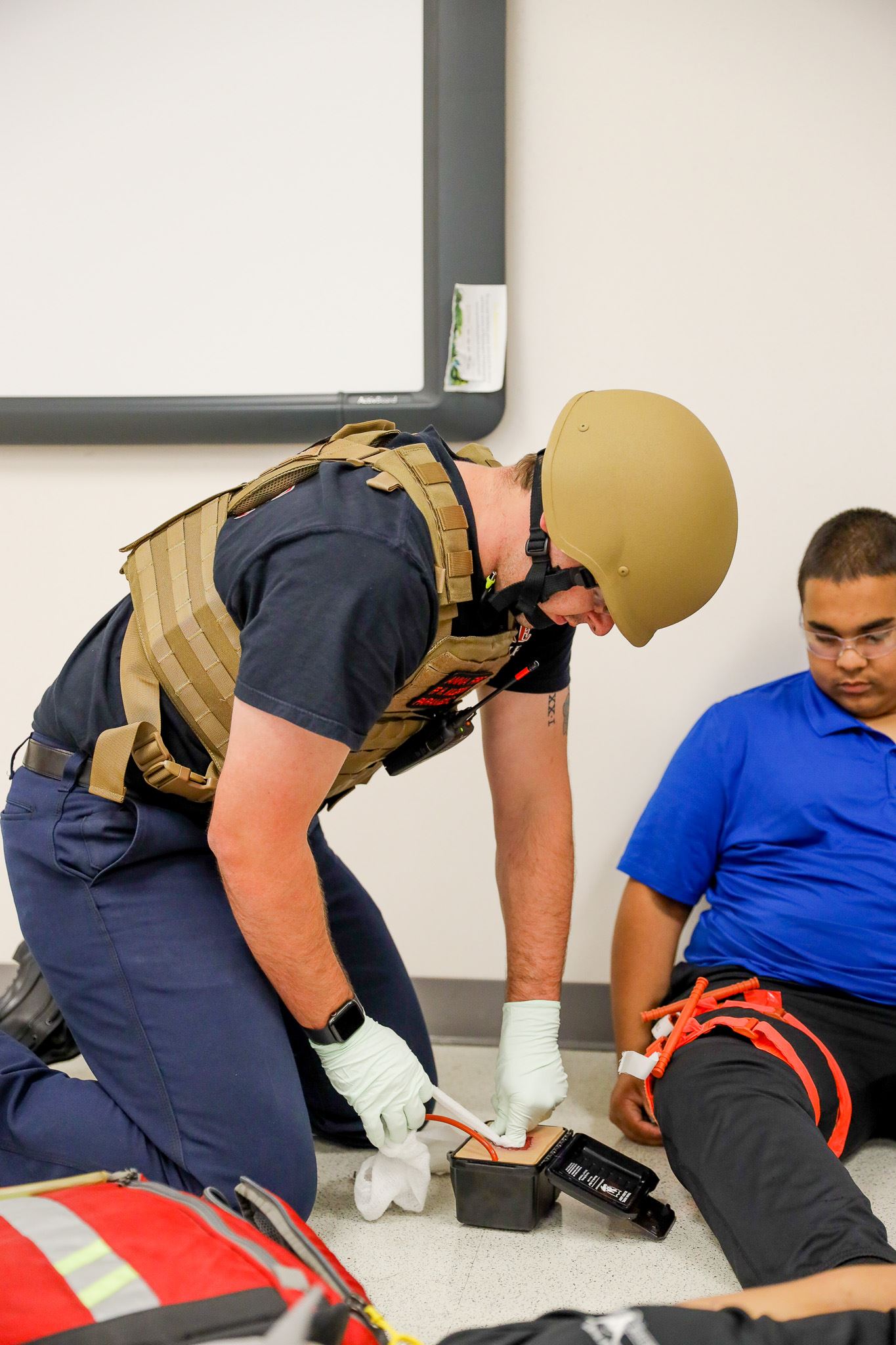 Firefighter using training gear on teenager